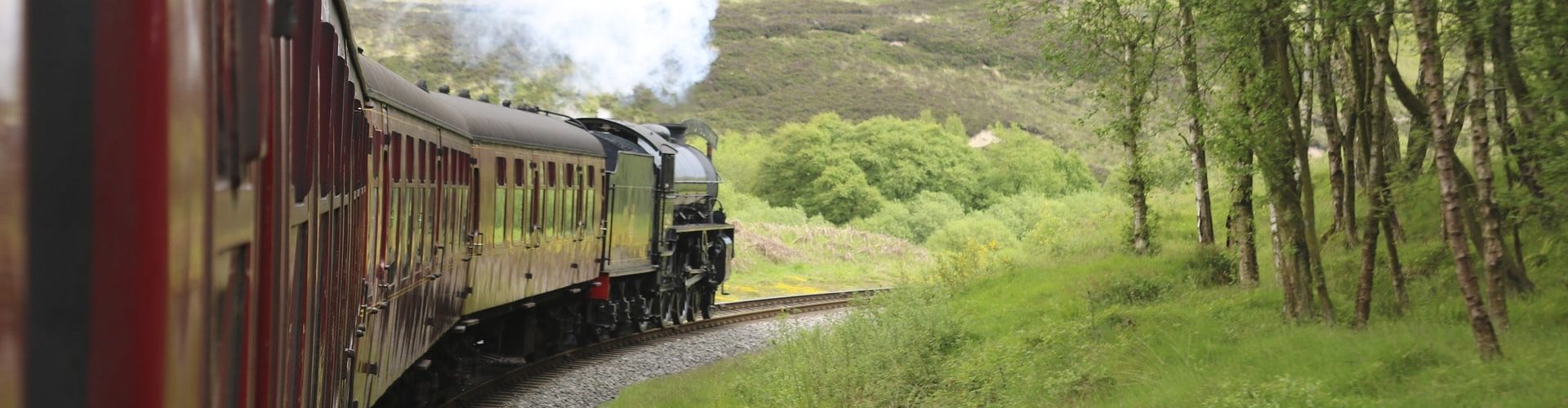 Steam train with red carriages